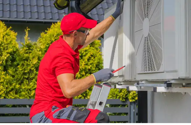 HVAC installer fitting a new outdoor air conditioning unit at a Central New York home