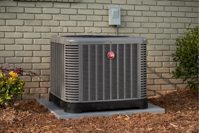 Newly installed Rheem outdoor air conditioning condenser beside a Central New York home